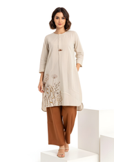 Woman wearing cream embroidered long kurta with floral motif paired with brown straight pants Soft, breathable fabric ideal for daily and office wear, Lightweight, easy-to-style ethnic wear set with premium finish - elegant ethnic wear by Indu Heritage