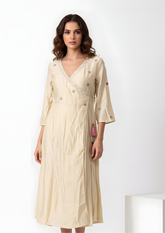 Model wearing beige kurta that redefines subtle elegance. Designed with embroidery and a structured cross knot top, this ensemble offers a polished yet relaxed look, perfect for office wear, travel, or brunch outings., relaxed top women’s ethnic fusion wear- Indu Heritage.Soft, breathable fabric for all-day comfort.Relaxed fit for all-day wear