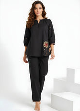 Model wearing black two-piece co-ord set with floral embroidery and relaxed top women’s ethnic fusion wear- Indu Heritage.Soft, breathable fabric for all-day comfort.Relaxed fit for all-day wear.Side pockets for added functionality.Lightweight, breathable cotton fabric ideal for all seasons