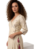 Model wearing beige kurta that redefines subtle elegance. Designed with embroidery and a structured cross knot top, this ensemble offers a polished yet relaxed look, perfect for office wear, travel, or brunch outings., relaxed top women’s ethnic fusion wear- Indu Heritage.Soft, breathable fabric for all-day comfort.Relaxed fit for all-day wear