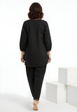 Model wearing black two-piece co-ord set with floral embroidery and relaxed top women’s ethnic fusion wear- Indu Heritage.Soft, breathable fabric for all-day comfort.Relaxed fit for all-day wear.Side pockets for added functionality.Lightweight, breathable cotton fabric ideal for all seasons
