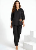 Model wearing black two-piece co-ord set with floral embroidery and relaxed top women’s ethnic fusion wear- Indu Heritage.Soft, breathable fabric for all-day comfort.Relaxed fit for all-day wear.Side pockets for added functionality.Lightweight, breathable cotton fabric ideal for all seasons